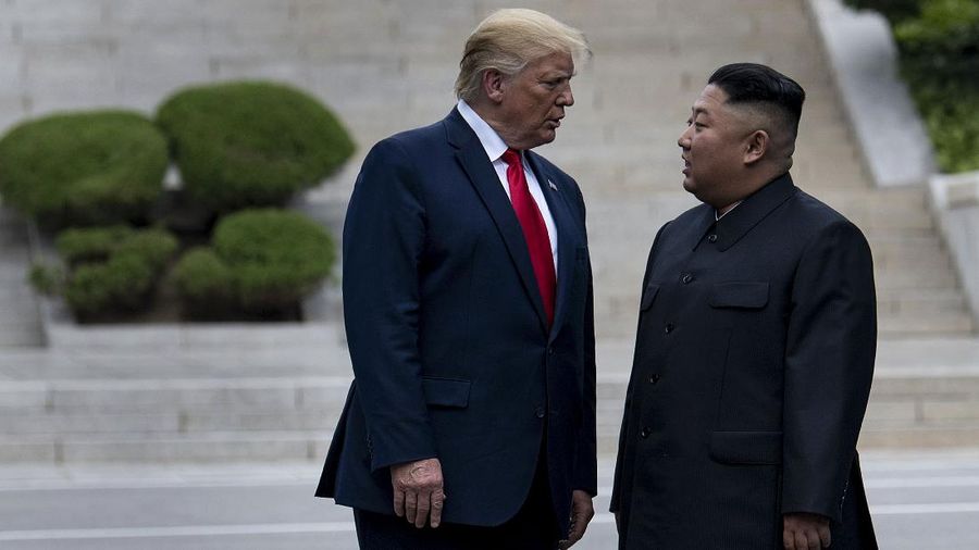US President Donald Trump and North Korea's leader Kim Jong-un stand on North Korean soil while walking to South Korea in the Demilitarized Zone(DMZ) on June 30, 2019, in Panmunjom, Korea. (Photo by Brendan Smialowski / AFP)