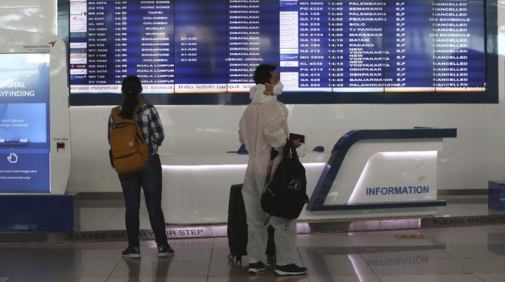 A man sits an empty arrival gate at Soekarno-Hatta International Airport in Tangerang, Indonesia, Indonesia on Friday, April 24, 2020. Indonesia is suspending passenger flights and rail service as it restricts people in the world's most populous Muslim nation from traveling to their hometowns during the Islamic holy month of Ramadan because of the coronavirus outbreak.(AP Photo/Tatan Syuflana)