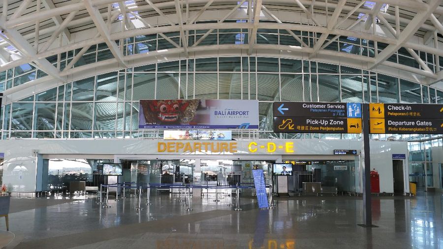 Police officers stand guard at the Ngurah Rai airport, Friday, April 24, 2020, in Bali, Indonesia. Indonesia is suspending passenger flights and rail service as it restricts people in the world's most populous Muslim nation from traveling to their hometowns during the Islamic holy month of Ramadan because of the coronavirus outbreak. (AP Photo/Firdia Lisnawati)
