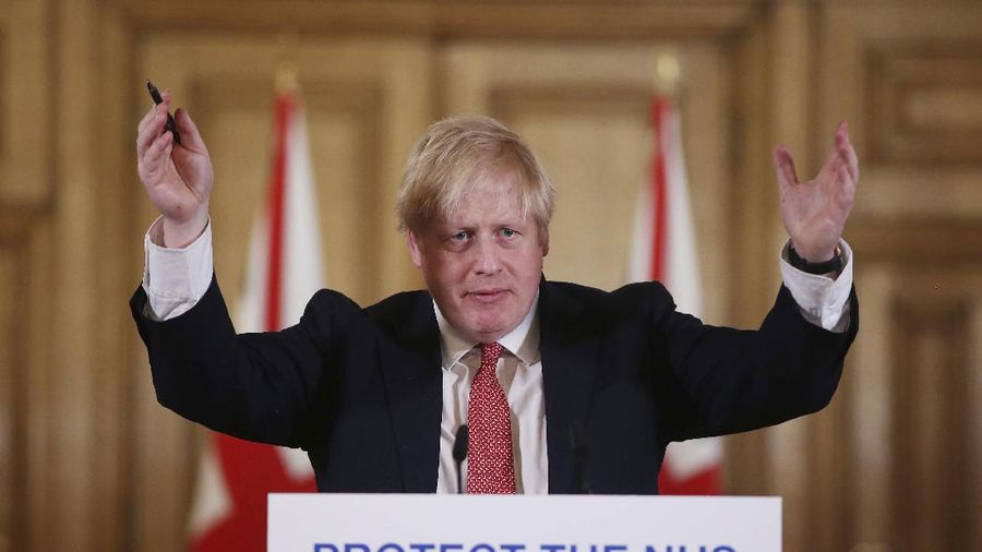 FILE - In this Sunday March 22, 2020 file photo British Prime Minister Boris Johnson gestures during his daily COVID 19 coronavirus press briefing to announce new measures to limit the spread of the virus, at Downing Street in London. The British prime minister's office says Boris Johnson will return to work Monday April 27, 2020, two weeks after he was discharged from a London hospital where he was treated for the new coronavirus. (Ian Vogler / Pool via AP, File)