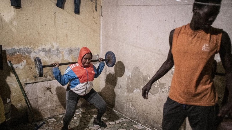 In this photo taken Saturday, April 25, 2020, the family of Bara Tambedou exercises at home after breaking the fast on the first day of the Muslim holy month of Ramadan, in Dakar, Senegal. This year the family is celebrating Ramadan at home, with prohibitions on public gatherings and a dusk-to-dawn curfew in place to curb the spread of the new coronavirus. (AP Photo/Sylvain Cherkaoui)