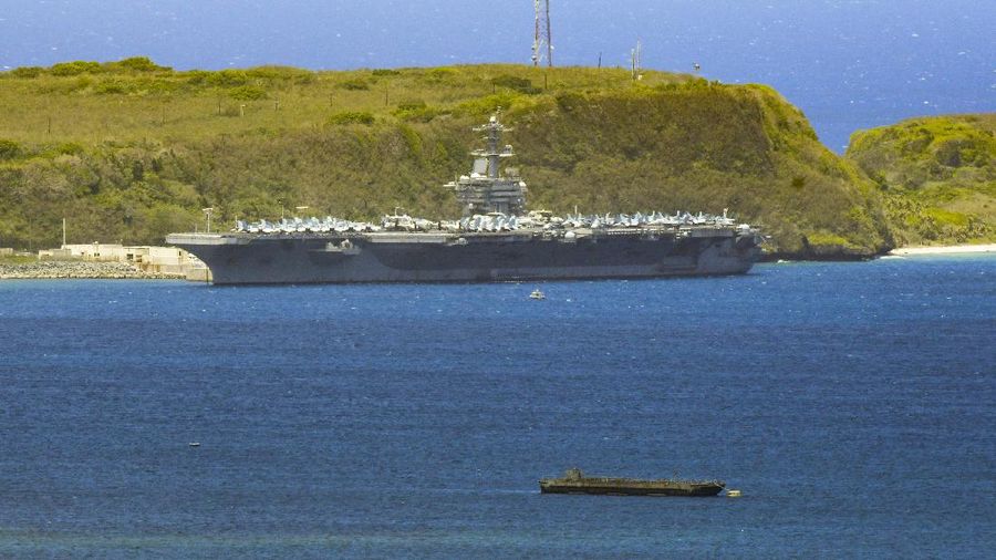 FILE - In this April 3, 2020, file photo, the USS Theodore Roosevelt, a Nimitz-class nuclear powered aircraft carrier, is docked along Kilo Wharf of Naval Base Guam. The U.S. Navy says that after weeks of work, all of the roughly 4,800 sailors on the coronavirus-stricken USS Theodore Roosevelt aircraft carrier have been tested for the virus. The ship has been sidelined in Guam since March 27, moving sailors ashore, testing them and isolating them for nearly a month.(Rick Cruz/The Pacific Daily via AP, File)