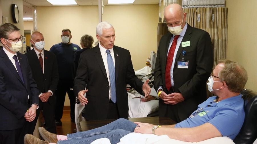 Vice President Mike Pence visits the molecular testing lab at Mayo Clinic Tuesday, April 28, 2020, in Rochester, Minn., where he toured the facilities supporting COVID-19 research and treatment. Pence chose not to wear a face mask while touring the Mayo Clinic in Minnesota. It's an apparent violation of the world-renowned medical center's policy requiring them. (AP Photo/Jim Mone)