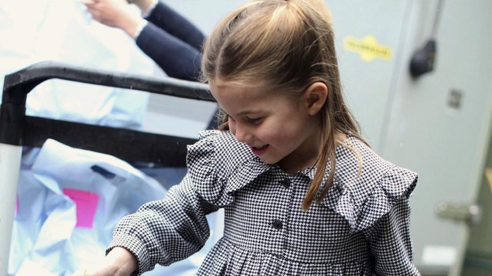 In this undated handout photo released by Kensington Palace, Britain's Princess Charlotte helps to deliver food packages for isolated pensioners in the local area along with her family, on the Sandringham Estate in King's Lynn, England. Princess Charlotte celebrates her fifth birthday on Saturday, May 2, 2020. (Duchess of Cambridge/Kensington Palace via AP)