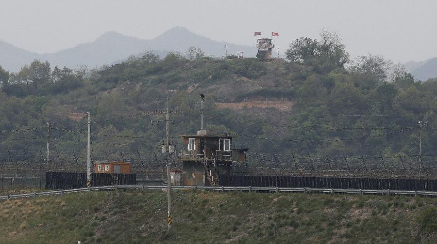 FILE - In this Dec. 16, 2019, file photo, South Korean army soldiers patrol along the barbed-wire fence in Paju, South Korea, near the border with North Korea. The Joint Chiefs of Staffs in Seoul said that North Korean troops fired several bullets at a South Korean guard post inside the heavily fortified border between the countries on Sunday, May 3, 2020. (AP Photo/Ahn Young-joon, File)