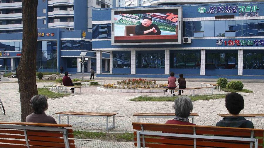 People in a park watch news broadcasted on a giant screen showing leader Kim Jong Un attending the opening ceremony of the Sunchon Phosphatic Fertilizer Factory Saturday, May, 2nd. 2020, in Pyongyang, North Korea. Un made his first public appearance in 20 days as he celebrated the completion of a fertilizer factory near Pyongyang, state media said Saturday, ending an absence that had triggered global rumors that he may be seriously ill. (AP Photo/Cha Song Ho)