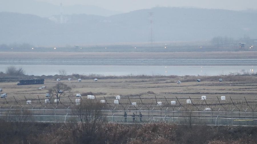 FILE - In this Dec. 16, 2019, file photo, South Korean army soldiers patrol along the barbed-wire fence in Paju, South Korea, near the border with North Korea. The Joint Chiefs of Staffs in Seoul said that North Korean troops fired several bullets at a South Korean guard post inside the heavily fortified border between the countries on Sunday, May 3, 2020. (AP Photo/Ahn Young-joon, File)
