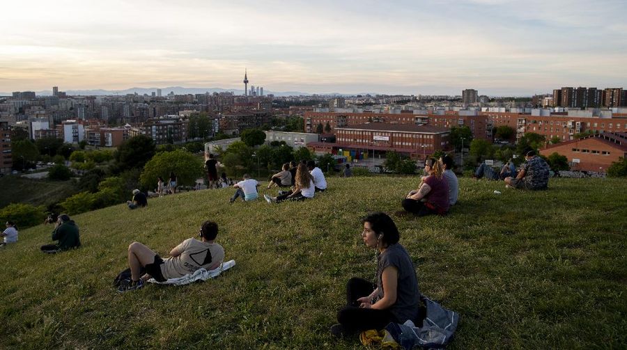 People sit in the Cerro del Tio Pio park in Madrid, Spain, Spain, Sunday, May 3, 2020. On Saturday, Spaniards were able to go outdoors to do exercise for the first time in seven weeks since the lockdown began to battle the coronavirus outbreak. (AP Photo/Manu Fernandez)