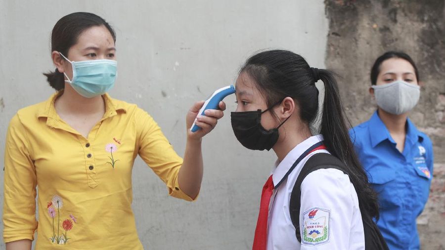 Students wearing masks attend a class in Dinh Cong secondary school in Hanoi, Vietnam Monday, May 4, 2020. Students across Vietnam return to school after three months of studying online due to school closure to contain the spread of COVID-19. (AP Photo/Hau Dinh)