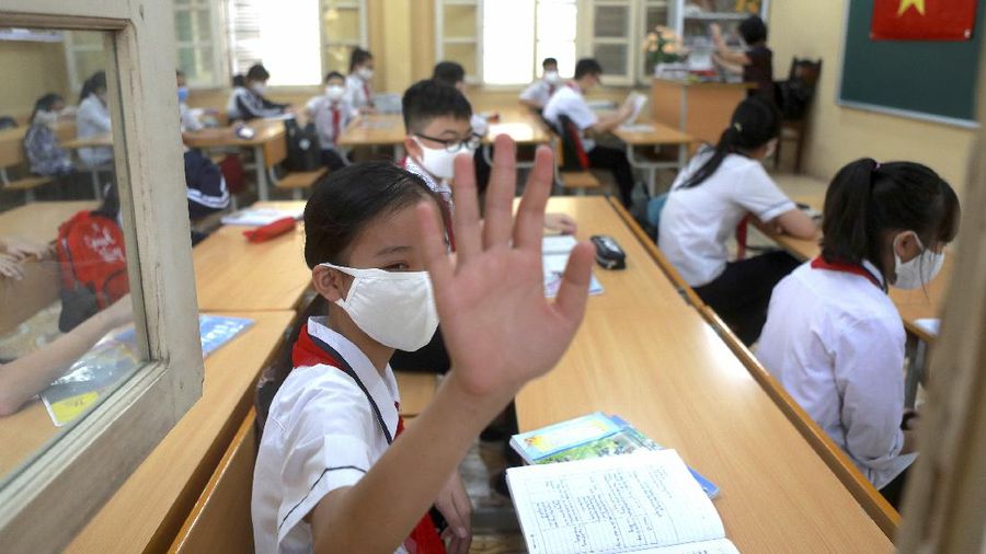 Students wearing masks attend a class in Dinh Cong secondary school in Hanoi, Vietnam Monday, May 4, 2020. Students across Vietnam return to school after three months of studying online due to school closure to contain the spread of COVID-19. (AP Photo/Hau Dinh)