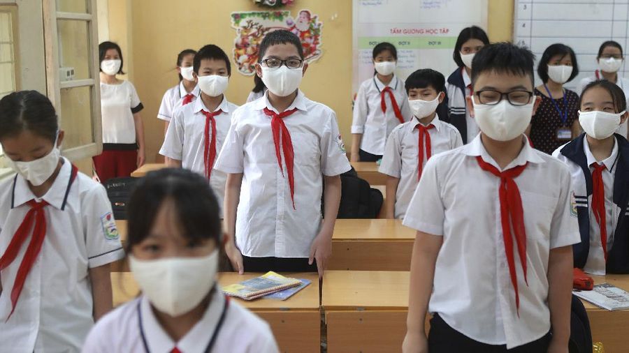 Students wearing masks attend a class in Dinh Cong secondary school in Hanoi, Vietnam Monday, May 4, 2020. Students across Vietnam return to school after three months of studying online due to school closure to contain the spread of COVID-19. (AP Photo/Hau Dinh)