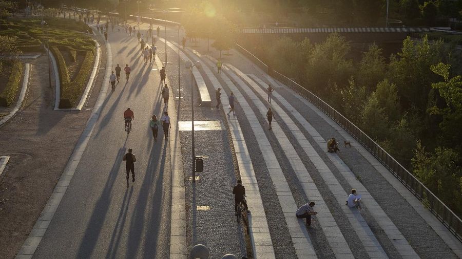 People exercise on a seafront promenade in Barcelona, Spain, Sunday, May 3, 2020. Spaniards have filled the streets of the country to do exercise after seven weeks of confinement to their homes to fight the coronavirus pandemic. People ran, walked, or rode bicycles under a brilliant sunny sky in Barcelona on Saturday, where many flocked to the maritime promenade to get as close as possible to the still off-limits beach. (AP Photo/Emilio Morenatti)