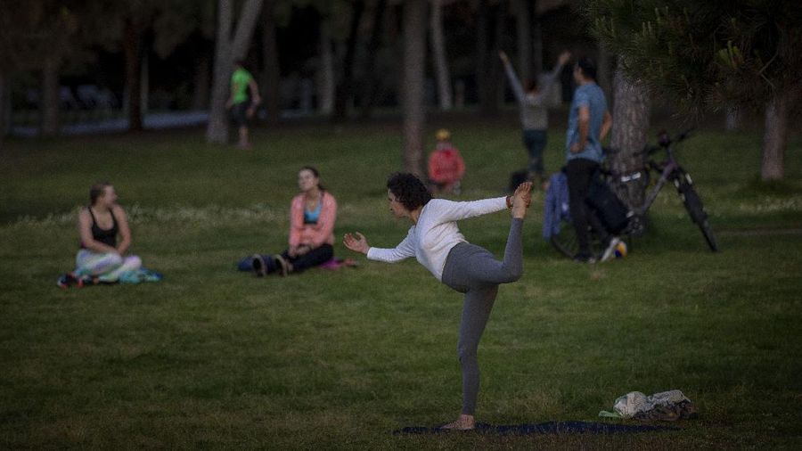 People exercise on a seafront promenade in Barcelona, Spain, Sunday, May 3, 2020. Spaniards have filled the streets of the country to do exercise after seven weeks of confinement to their homes to fight the coronavirus pandemic. People ran, walked, or rode bicycles under a brilliant sunny sky in Barcelona on Saturday, where many flocked to the maritime promenade to get as close as possible to the still off-limits beach. (AP Photo/Emilio Morenatti)