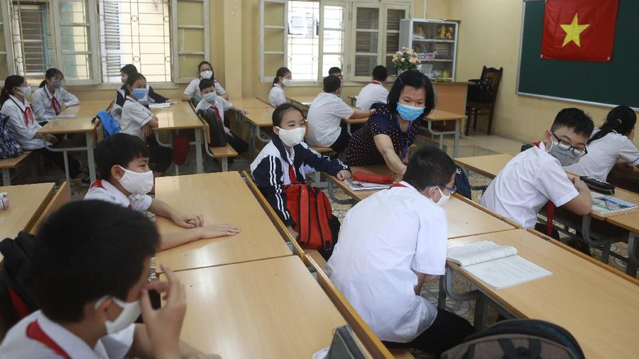 Students wearing masks attend a class in Dinh Cong secondary school in Hanoi, Vietnam Monday, May 4, 2020. Students across Vietnam return to school after three months of studying online due to school closure to contain the spread of COVID-19. (AP Photo/Hau Dinh)