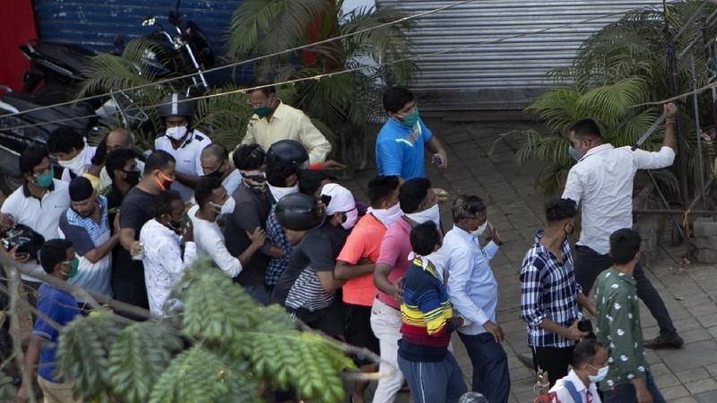 Indians line up to buy liquor outside one of the liquor shops which was reopened Monday after six weeks lockdown on the outskirts of New Delhi, India, Monday, May 4, 2020. India's six-week coronavirus lockdown, which was supposed to end on Monday, has been extended for another two weeks, with a few relaxations. Locking down the country's 1.3 billion people has slowed down the spread of the virus, but has come at the enormous cost of upending lives and millions of lost jobs. (AP Photo/Altaf Qadri)
