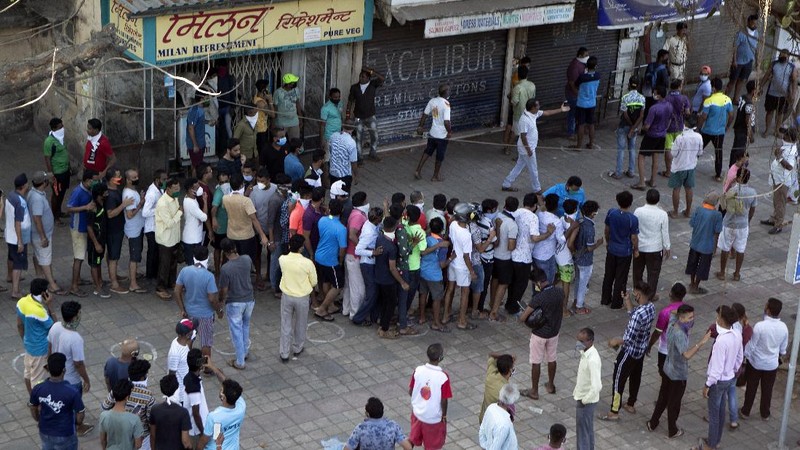 Indians line up to buy liquor outside one of the liquor shops which was reopened Monday after six weeks lockdown on the outskirts of New Delhi, India, Monday, May 4, 2020. India's six-week coronavirus lockdown, which was supposed to end on Monday, has been extended for another two weeks, with a few relaxations. Locking down the country's 1.3 billion people has slowed down the spread of the virus, but has come at the enormous cost of upending lives and millions of lost jobs. (AP Photo/Altaf Qadri)