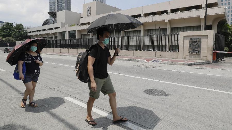 A man wearing a mask passes by the headquarters of broadcast network ABS-CBN Corp. on Wednesday May 6, 2020 in Manila, Philippines. Philippine church and business leaders expressed alarm Wednesday over a government agency’s shutdown of the country’s largest TV and radio network, which has been a major provider of news on the coronavirus pandemic. (AP Photo/Aaron Favila)