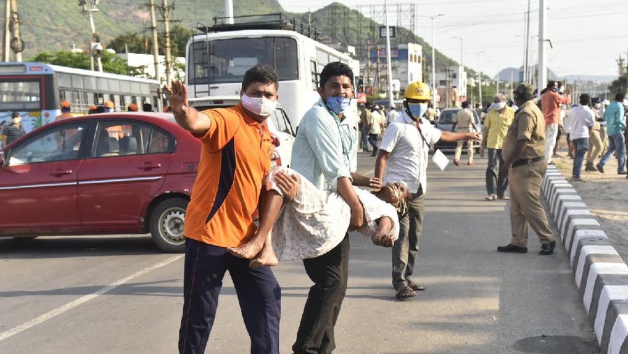 Firefighters walk with oxygen cylinders outside LG Polymers plant, the site of a chemical gas leak, in Vishakhapatnam, India, Thursday, May 7, 2020. Synthetic chemical styrene leaked from the industrial plant in southern India early Thursday, leaving people struggling to breathe and collapsing in the streets as they tried to flee. Administrator Vinay Chand said several people fainted on the road and were rushed to a hospital. (AP Photo)