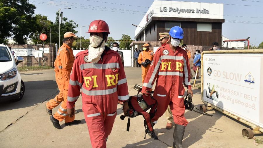 Firefighters walk with oxygen cylinders outside LG Polymers plant, the site of a chemical gas leak, in Vishakhapatnam, India, Thursday, May 7, 2020. Synthetic chemical styrene leaked from the industrial plant in southern India early Thursday, leaving people struggling to breathe and collapsing in the streets as they tried to flee. Administrator Vinay Chand said several people fainted on the road and were rushed to a hospital. (AP Photo)