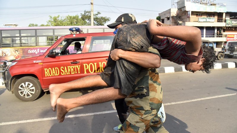 Firefighters walk with oxygen cylinders outside LG Polymers plant, the site of a chemical gas leak, in Vishakhapatnam, India, Thursday, May 7, 2020. Synthetic chemical styrene leaked from the industrial plant in southern India early Thursday, leaving people struggling to breathe and collapsing in the streets as they tried to flee. Administrator Vinay Chand said several people fainted on the road and were rushed to a hospital. (AP Photo)