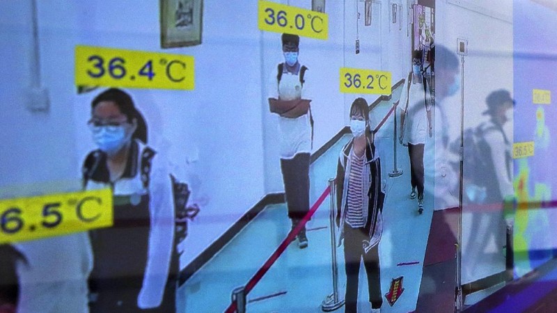 Students wearing protective face masks to help curb the spread of the new coronavirus walk in social distancing as they arrive to a high school in Wuhan in central China's Hubei province, Wednesday, May 6, 2020. Senior students returned to classes on Wednesday in the central Chinese city of Wuhan, the epicenter of the coronavirus pandemic, after no new cases or deaths were reported from the outbreak that had prompted a 76-day quarantine in the city of 11 million. (Chinatopix via AP)
