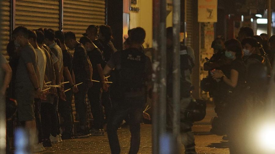 A police officer stand guard as more than 200 people were arrested during anti-government protests in Hong Kong early Monday, May 11, 2020. A pro-democracy movement that paralyzed Hong Kong for months last year has shown signs of reviving in recent weeks as the coronavirus threat eases. The government recently decided to allow public gatherings of eight people, up from four previously. (AP Photo/Vincent Yu)