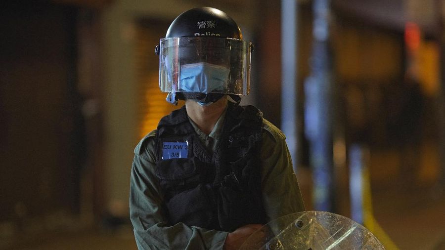 A police officer stand guard as more than 200 people were arrested during anti-government protests in Hong Kong early Monday, May 11, 2020. A pro-democracy movement that paralyzed Hong Kong for months last year has shown signs of reviving in recent weeks as the coronavirus threat eases. The government recently decided to allow public gatherings of eight people, up from four previously. (AP Photo/Vincent Yu)