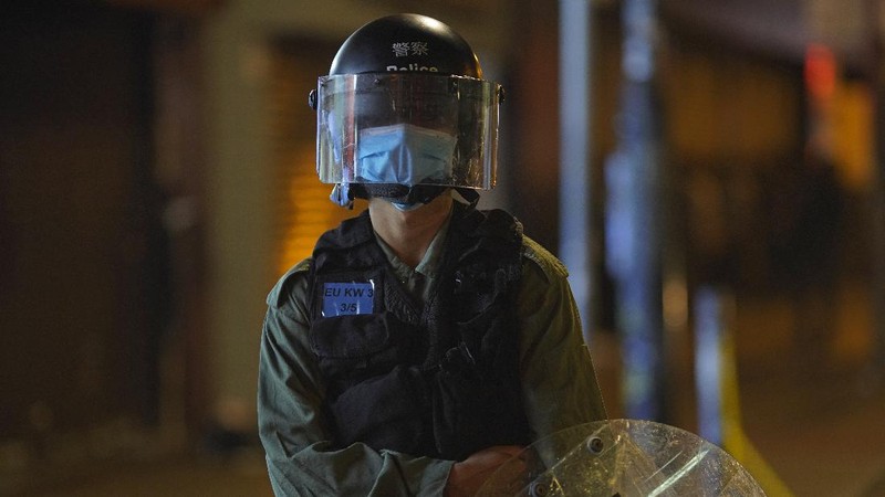 A police officer stand guard as more than 200 people were arrested during anti-government protests in Hong Kong early Monday, May 11, 2020. A pro-democracy movement that paralyzed Hong Kong for months last year has shown signs of reviving in recent weeks as the coronavirus threat eases. The government recently decided to allow public gatherings of eight people, up from four previously. (AP Photo/Vincent Yu)