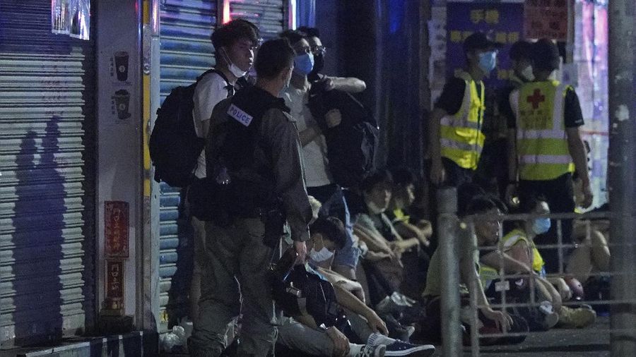A police officer stand guard as more than 200 people were arrested during anti-government protests in Hong Kong early Monday, May 11, 2020. A pro-democracy movement that paralyzed Hong Kong for months last year has shown signs of reviving in recent weeks as the coronavirus threat eases. The government recently decided to allow public gatherings of eight people, up from four previously. (AP Photo/Vincent Yu)