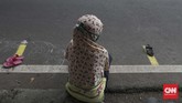 Sebelum pembagian takjil, warga sudah memasang tanda sandal di garis batas berwarna kuning sebagai tanda posisi antre dirinya. (CNNIndonesia/Safir Makki)