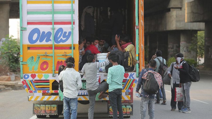 A migrant worker from Chhattisgarh state helps a child climb onto a truck to travel to their villages hundreds of miles away, during a nationwide lockdown to curb the spread of new coronavirus on the outskirts of Hyderabad, India, Tuesday, May 12, 2020. The lockdown that began March 25 sent an exodus of workers from its huge informal sector fleeing the cities to their ancestral homes in the countryside. Economists say unemployment reached 24.7% this week. (AP Photo/Mahesh Kumar A)