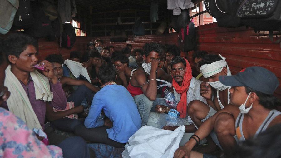 A migrant worker from Chhattisgarh state helps a child climb onto a truck to travel to their villages hundreds of miles away, during a nationwide lockdown to curb the spread of new coronavirus on the outskirts of Hyderabad, India, Tuesday, May 12, 2020. The lockdown that began March 25 sent an exodus of workers from its huge informal sector fleeing the cities to their ancestral homes in the countryside. Economists say unemployment reached 24.7% this week. (AP Photo/Mahesh Kumar A)