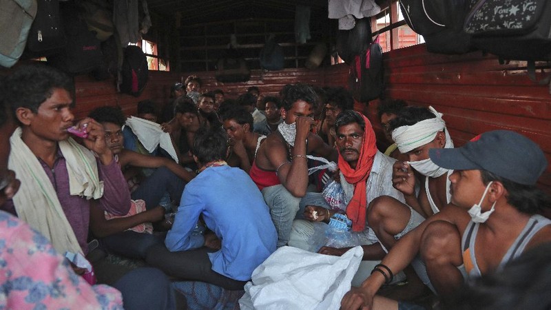 A migrant worker from Chhattisgarh state helps a child climb onto a truck to travel to their villages hundreds of miles away, during a nationwide lockdown to curb the spread of new coronavirus on the outskirts of Hyderabad, India, Tuesday, May 12, 2020. The lockdown that began March 25 sent an exodus of workers from its huge informal sector fleeing the cities to their ancestral homes in the countryside. Economists say unemployment reached 24.7% this week. (AP Photo/Mahesh Kumar A)