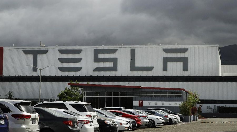 A truck loaded with Tesla cars departs the Tesla plant Tuesday, May 12, 2020, in Fremont, Calif. Tesla CEO Elon Musk has emerged as a champion of defying stay-home orders intended to stop the coronavirus from spreading, picking up support as well as critics on social media. Among supporters was President Donald Trump, who on Tuesday tweeted that Tesla's San Francisco Bay Area factory should be allowed to open despite health department orders to stay closed except for basic operations. (AP Photo/Ben Margot)