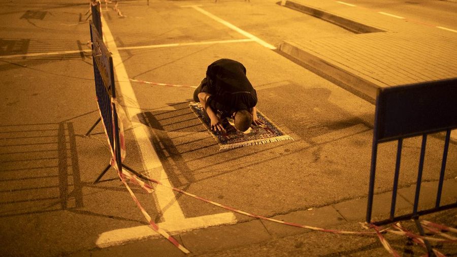 Muslim men keep social distancing as they pray after breaking their daytime fast, at a parking lot as mosques remain closed to prevent the spread of coronavirus pandemic during the holy month of Ramadan, in the mixed Arab Jewish city of Jaffa, near Tel Aviv, Israel, Sunday, May 10, 2020. (AP Photo/Oded Balilty)