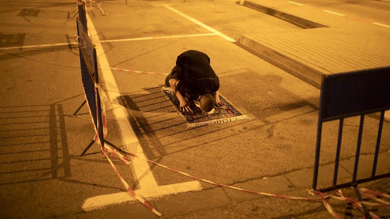 Muslim men keep social distancing as they pray after breaking their daytime fast, at a parking lot as mosques remain closed to prevent the spread of coronavirus pandemic during the holy month of Ramadan, in the mixed Arab Jewish city of Jaffa, near Tel Aviv, Israel, Sunday, May 10, 2020. (AP Photo/Oded Balilty)