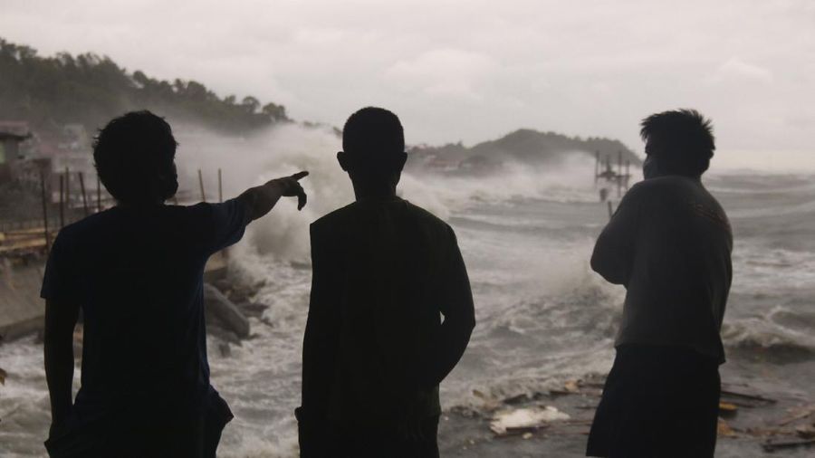 Dark clouds envelop the skies as workers fold a billboard to prepare for the coming of typhoon Vongfong in Manila, Philippines Thursday May, 14, 2020. The first typhoon to hit the country this year roared toward the eastern Philippines on Thursday as authorities work to evacuate tens of thousands of people while avoiding overcrowding in shelters that could spread the coronavirus. (AP Photo/Aaron Favila)