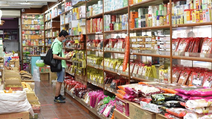 A man wearing a face mask looks at traditional Chinese medicinal products inside a Chinese medical hall in Singapore’s Chinatown district on Tuesday, May 12, 2020. Singapore has allowed selected businesses such as traditional Chinese medicine medical halls, home-based establishments, food manufacturing, selected food retail outlets, laundry services, traditional barbers and pet supplies to reopen May 12 in a cautious rollback of a two-month partial lockdown to curb the spread of COVID-19 infections in the city-state. (AP Photo / YK Chan)