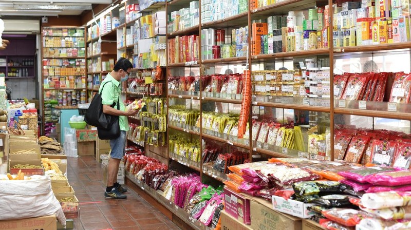 A man wearing a face mask looks at traditional Chinese medicinal products inside a Chinese medical hall in Singapore’s Chinatown district on Tuesday, May 12, 2020. Singapore has allowed selected businesses such as traditional Chinese medicine medical halls, home-based establishments, food manufacturing, selected food retail outlets, laundry services, traditional barbers and pet supplies to reopen May 12 in a cautious rollback of a two-month partial lockdown to curb the spread of COVID-19 infections in the city-state. (AP Photo / YK Chan)