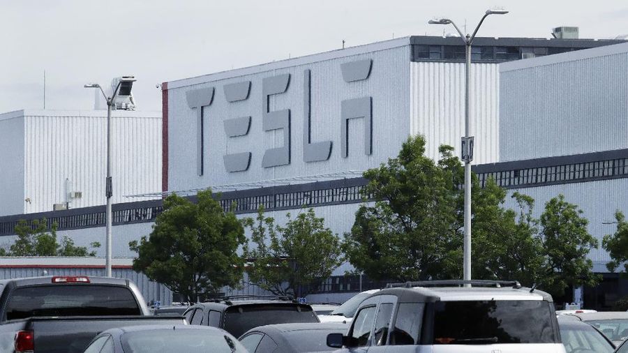 A truck loaded with Tesla cars departs the Tesla plant Tuesday, May 12, 2020, in Fremont, Calif. Tesla CEO Elon Musk has emerged as a champion of defying stay-home orders intended to stop the coronavirus from spreading, picking up support as well as critics on social media. Among supporters was President Donald Trump, who on Tuesday tweeted that Tesla's San Francisco Bay Area factory should be allowed to open despite health department orders to stay closed except for basic operations. (AP Photo/Ben Margot)