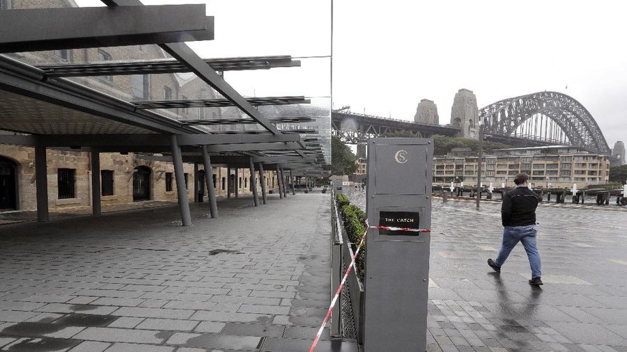 A popular dining area with several restaurants along the shoreline has no activity as stage 1 of the lifting of COVID-19 restrictions begin in Sydney, Friday, May 15, 2020. Some pubs, clubs and restaurants are reopening with a limit of 10 patrons while following distancing guidelines. (AP Photo/Rick Rycroft)