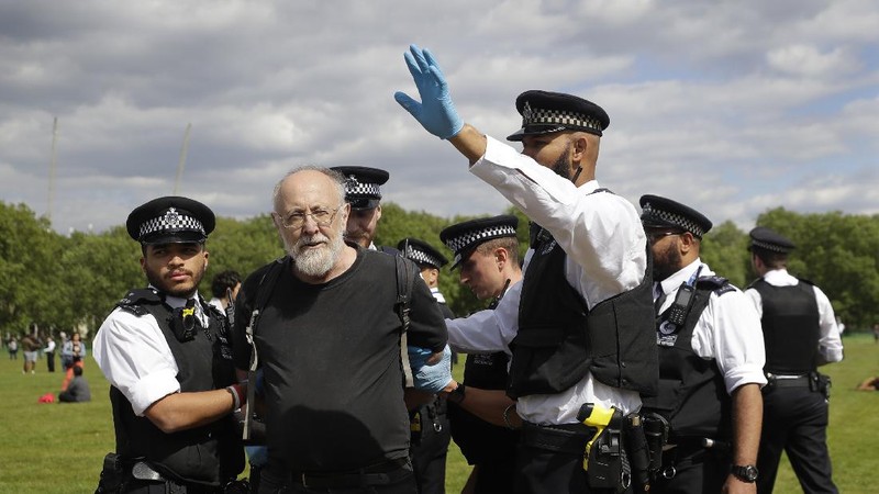 A man is arrested during a mass gathering protest organised by the group called 'UK Freedom Movement', in Hyde Park in London as the country is in lockdown to help stop the spread of coronavirus, Saturday, May 16, 2020. The group claims that the coronavirus lockdown is illegal. (AP Photo/Kirsty Wigglesworth)