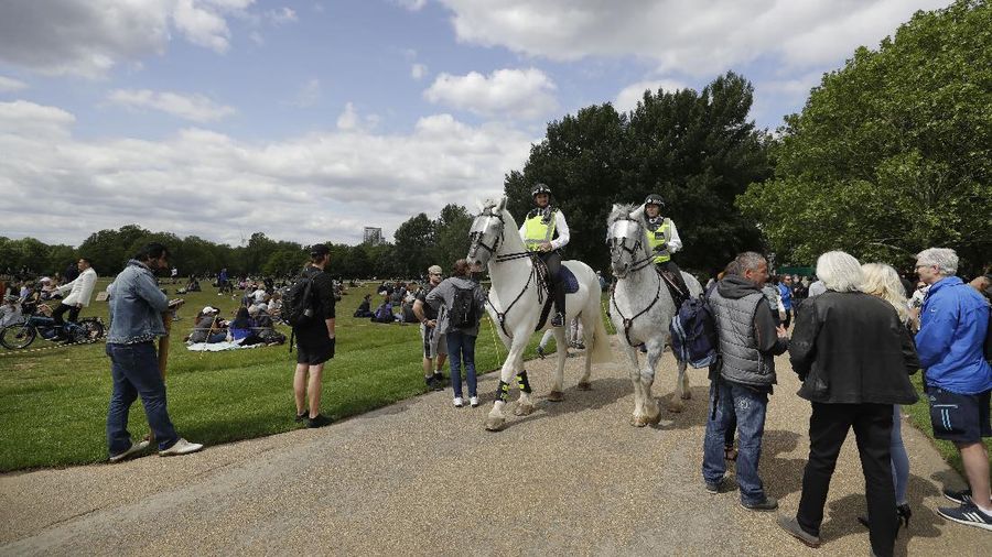 A man is arrested during a mass gathering protest organised by the group called 'UK Freedom Movement', in Hyde Park in London as the country is in lockdown to help stop the spread of coronavirus, Saturday, May 16, 2020. The group claims that the coronavirus lockdown is illegal. (AP Photo/Kirsty Wigglesworth)