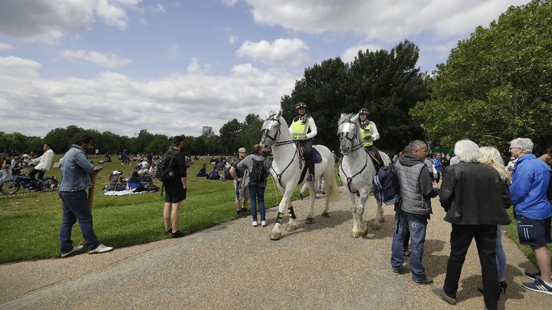 A man is arrested during a mass gathering protest organised by the group called 'UK Freedom Movement', in Hyde Park in London as the country is in lockdown to help stop the spread of coronavirus, Saturday, May 16, 2020. The group claims that the coronavirus lockdown is illegal. (AP Photo/Kirsty Wigglesworth)