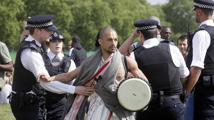A man is arrested during a mass gathering protest organised by the group called 'UK Freedom Movement', in Hyde Park in London as the country is in lockdown to help stop the spread of coronavirus, Saturday, May 16, 2020. The group claims that the coronavirus lockdown is illegal. (AP Photo/Kirsty Wigglesworth)