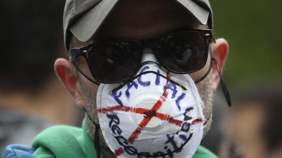 A man is arrested during a mass gathering protest organised by the group called 'UK Freedom Movement', in Hyde Park in London as the country is in lockdown to help stop the spread of coronavirus, Saturday, May 16, 2020. The group claims that the coronavirus lockdown is illegal. (AP Photo/Kirsty Wigglesworth)