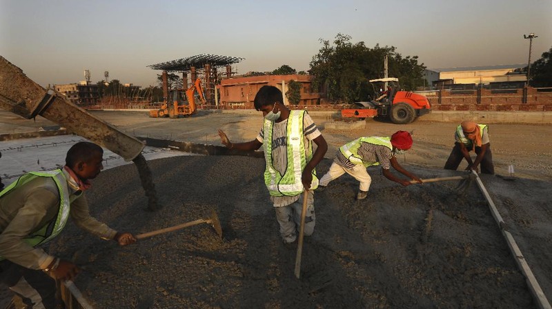 Migrant workers sit inside a truck, after they were stopped and directed towards a temporary shelter to register for free travel on a train, during lockdown to prevent the spread of new coronavirus on the outskirts of Hyderabad, India, Saturday, May 16, 2020. Tens of thousands of migrant laborers have been returning from big cities to their villages after losing jobs because of a countrywide lockdown imposed in late March to contain the spread of the coronavirus. (AP Photo/Mahesh Kumar A.)