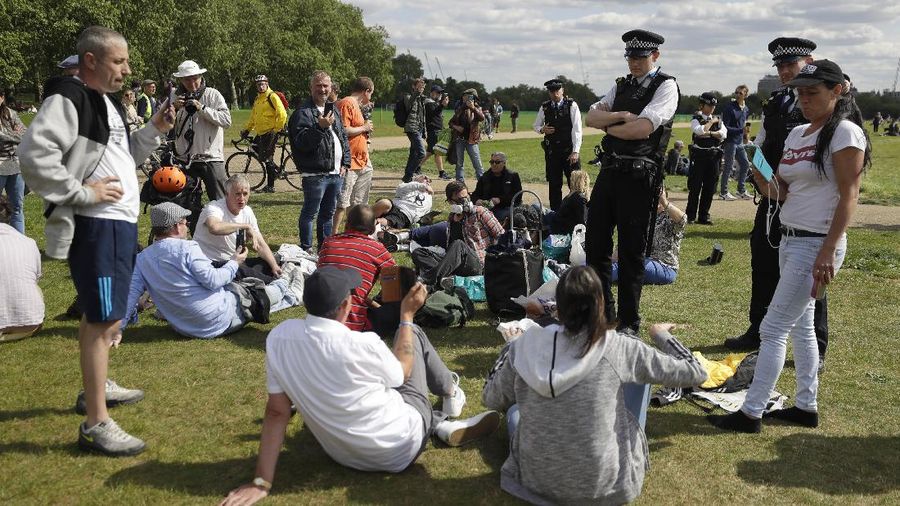A man is arrested during a mass gathering protest organised by the group called 'UK Freedom Movement', in Hyde Park in London as the country is in lockdown to help stop the spread of coronavirus, Saturday, May 16, 2020. The group claims that the coronavirus lockdown is illegal. (AP Photo/Kirsty Wigglesworth)