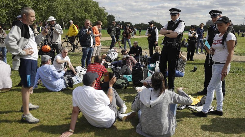 A man is arrested during a mass gathering protest organised by the group called 'UK Freedom Movement', in Hyde Park in London as the country is in lockdown to help stop the spread of coronavirus, Saturday, May 16, 2020. The group claims that the coronavirus lockdown is illegal. (AP Photo/Kirsty Wigglesworth)
