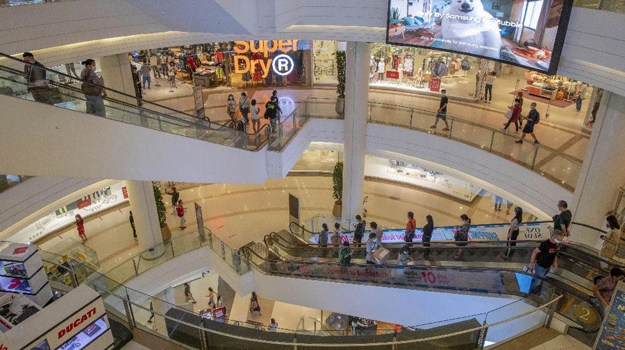 Patrons use escalators at the upmarket shopping mall Siam Paragon in Bangkok, Thailand, Sunday, May 17, 2020. Thai authorities allowed department stores, shopping malls and other businesses to reopen from Sunday, selectively easing restrictions meant to combat the coronavirus. (AP Photo/ Gemunu Amarasinghe)